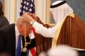 Saudi King Salman presents President Donald Trump with The Collar of Abdulaziz Al Saud Medal at the Royal Court Palace.