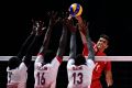 Mohamed Al Hachdadi of Morocco spikes the ball in the Mens Volleyball Group B match between Qatar and Morocco.