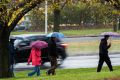 People braving the rain on Commonweath Avenue.