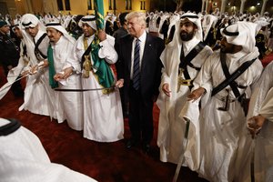 President Donald Trump holds a sword and sways with traditional dancers during a welcome ceremony at Murabba Palace, Saturday, May 20, 2017, in Riyadh.