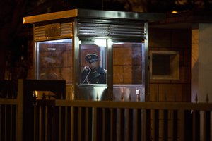 File - A paramilitary policeman makes a call at the entrance to the North Korean embassy in Beijing, early Friday, March 31, 2017.