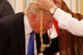 Saudi King Salman presents President Donald Trump with the Collar of Abdulaziz Medal in  Riyadh.