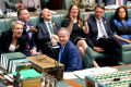 Bill Shorten and his frontbench laugh as Scott Morrison approaches the despatch box during Question Time.