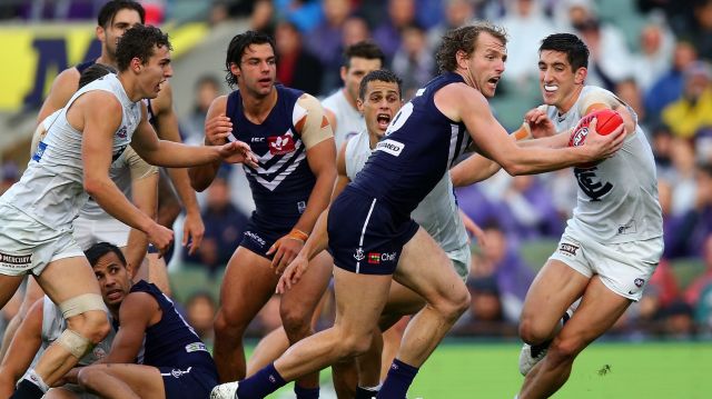 Docker David Mundy fights to clear the ball against the Blues.