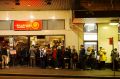 People queuing to enter Mamak restaurant in Chinatown, Sydney. 