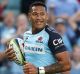 All smiles: Israel Folau scores for the Waratahs during a 50-23 thumping of the Melbourne Rebels.
