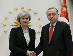 Turkey's President Recep Tayyip Erdogan, right, shakes hands with British Prime Minister Theresa May, left, prior to their meeting at the Presidential Palace in Ankara, Turkey, Saturday, Jan. 28, 2017.