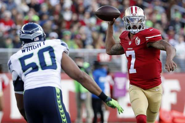 San Francisco 49ers quarterback Colin Kaepernick (7) passes against Seattle Seahawks outside linebacker K.J. Wright (50) during the first half of an NFL football game in Santa Clara, Calif., Sunday, Jan. 1, 2017. (AP Photo/Tony Avelar)