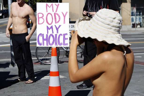 Inti Gonzalez photographs participants during the first annual Valentine's Nude Parade put together by the Body Freedom Network, in San Francisco, Calif., on Saturday Feb. 13, 2016