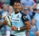 All smiles: Israel Folau scores for the Waratahs during a 50-23 thumping of the Melbourne Rebels.