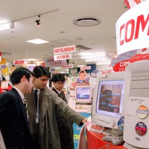 Consumers try one of the latest desktop computers from Compaq in 1997 - Reuters