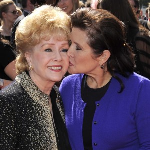 FILE- In this Sept. 10, 2011, file photo, Debbie Reynolds, left, and Carrie Fisher arrive at the Primetime Creative Arts Emmy Awards in Los Angeles. Reynolds, star of the 1952 classic "Singin' in the Rain" died Wednesday, Dec. 28, 2016, according to her son Todd Fisher. She was 84. (AP Photo/Chris Pizzello, File)