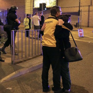 Armed police stand guard at Manchester Arena after reports of an explosion at the venue during an Ariana Grande gig  in Manchester, England Monday, May 22, 2017. Police says there are "a number of fatalities" after reports of an explosion at an Ariana Grande concert in northern England. (Peter Byrne/PA via AP)