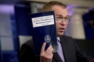 Budget Director Mick Mulvaney holds up a copy of President Donald Trump's proposed fiscal 2018 federal budget as he speaks to members of the media in the Press Briefing Room of the White House in Washington, Tuesday, May 23, 2017.