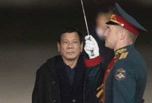 Philippine President Rodrigo Duterte reviews honour guards upon his arrival at government airport Vnukovo II just outside Moscow, Russia, late Monday, May 22, 2017.