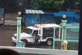 A seized police vehicle flies a black Islamic State-style flag on the streets of Marawi City on Tuesday.