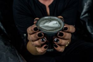 Nat Lange from Espresso Yourself coffee van and her new trend Goth lattes- coffee made with activated charcoal. Photo by ...