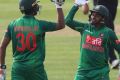 Bangladesh's Mahmudullah, left, celebrates with teammate Mushfiqur Rahim after hitting a four to win the Tri-Nations ...