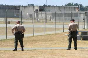 In this Aug. 17, 2011 file photo, correctional officers keep watch on imates on the recreation yard at Pelican Bay State Prison near Crescent City, Calif.