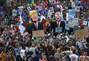 Protesters carry effigies of US President Donald Trump and Belgian PM Charles Michel during a demonstration in the center of Brussels on Wednesday, May 24, 2017.