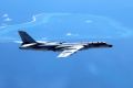 A Chinese H-6K bomber patrols the islands and reefs in the South China Sea. 