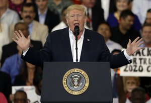 President Donald Trump gestures during his "Make America Great Again Rally" at Orlando-Melbourne International Airport Saturday, Feb. 18, 2017, in Melbourne, Fla.