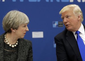 U.S. President Donald Trump, right, speaks to British Prime Minister Theresa May during in a working dinner meeting at the NATO headquarters during a NATO summit of heads of state and government in Brussels on Thursday, May 25, 2017.