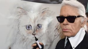 Karl Lagerfeld with a painting of his beloved cat Choupette.