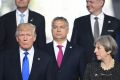 Mr Trump and Prime Minister Theresa May with other NATO leaders at the meeting.