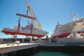 61901001728.jpg 

CAPTION   Petrol boats made for the Yemeni Government are loaded onto a mother ship for transport to ...