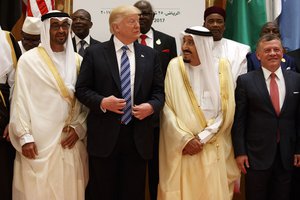 President Donald Trump talks with Saudi King Salman as they pose for photos with leaders at the Arab Islamic American Summit, at the King Abdulaziz Conference Center, Sunday, May 21, 2017, in Riyadh, Saudi Arabia. Jordan's King Abdallah II stands at right.