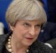 British PM Theresa May listens to US President Donald Trump at a NATO dinner in Brussels on Thursday.