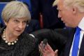 British PM Theresa May listens to US President Donald Trump at a NATO dinner in Brussels on Thursday.