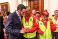 Premier Daniel Andrews with one of the walk organisers, Charles Zhang, after the apology.