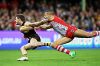 SYDNEY, AUSTRALIA - MAY 26:  Blake Hardwick of the Hawks is challenged by Lance Franklin of the Swans during the round ...