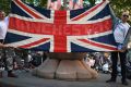Scooter enthusiasts hold up a Union Jack flag as they arrive at St Ann's square to pay tribute to Olivia Campbell, who ...
