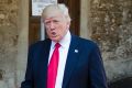 US President Donald Trump arrives alone to a G7 session on Saturday.