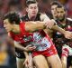 Reined in: Kurt Tippett is tackled during Hawthorn's last minute win over the Swans, who almost staged a comeback at the SCG.