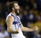 Luke McDonald of the Kangaroos celebrates after kicking a goal at Etihad Stadium on Sunday.