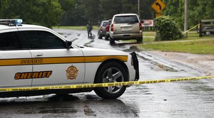 A Lincoln County Sheriff's vehicle and evidence tape block a street Sunday, May 28, 2017, in Brookhaven, Mississippi, where several people were fatally shot Saturday evening.