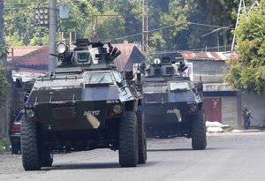 Armored Personnel Carriers drive to the frontline in the continuing assaults to retake control of some areas of Marawi city Sunday, May 28, 2017 in southern Philippines.