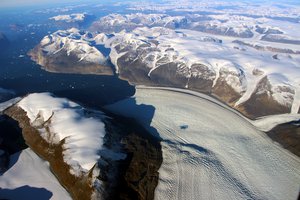 Rink Glacier in western Greenland, with a meltwater lake visible center. A new NASA study finds that during Greenland's hottest summers on record, 2010 and 2012, the ice in Rink Glacier on the island's west coast didn't just melt faster than usual, it slid through the glacier's interior in a gigantic wave, like a warmed freezer pop sliding out of its plastic casing.