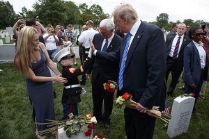 Brittany Jacobs, left, and her 6-year-old son Christian Jacobs meet President Donald Trump and Vice President Mike Pence in Section 60 of Arlington National Cemetery, Monday, May 29, 2017, in Arlington, Va.