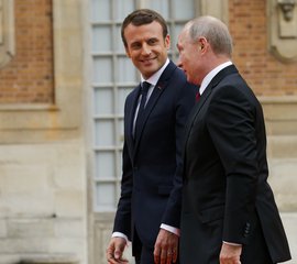 Russian President Vladimir Putin, right, and French President Emmanuel Macron talk to each other at the Palace of Versailles, near Paris, France, Monday, May 29, 2017.