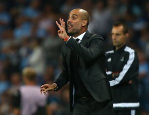 Manchester City's manager Pep Guardiola gestures towards his players during the Champions League group C soccer match at the Etihad Stadium between Manchester City and Borussia Moenchengladbach in Manchester, England, Wednesday, Sept. 14, 2016.