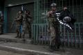 A soldier carries an Islamic State flag seized while clearing a street of militants in Marawi city, southern Philippines. 