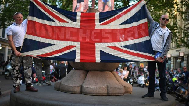 Scooter enthusiasts hold up a Union Jack flag as they arrive at St Ann's square to pay tribute to Olivia Campbell, who ...