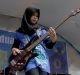 Widi Rahmawati (L) and Firdda Kurnia, members of the metal band Voice of Baceprot, perform during a school's farewell ...