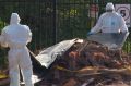 An emergency HAZMAT crew respond to dumped building material found on a suburban back street on Saturday.