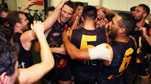 The Hawks' Ty Vickery celebrates with teammates after the round 10 win against the Sydney Swans.
